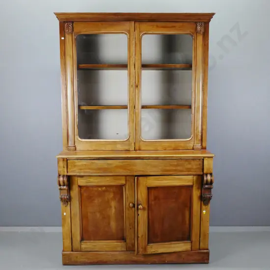 Victorian cedar bookcase-chiffonier with 2 glazed doors, 2 inner shelves, carved corbels and pilsasters, back lined with