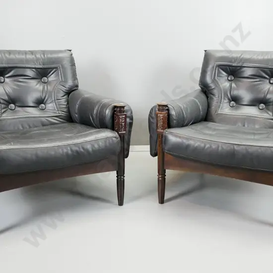 pair of mid-century leather slung armchairs with stitched leather panels and large buttons, turned front legs with