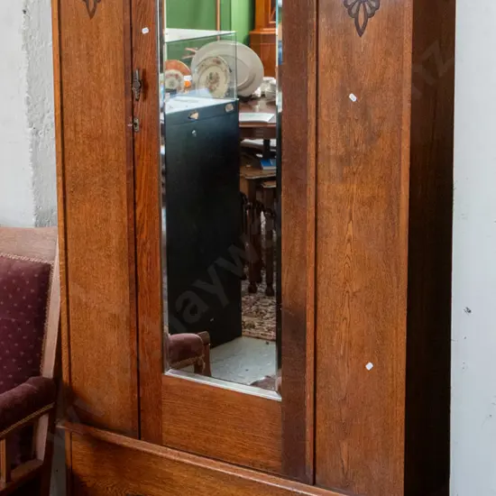 deco oak cab-leg single door wardrobe with oval bevelled edge mirror, single drawer, on casters. Some tape marks on door