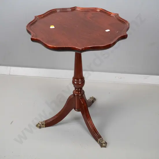reproduction mahogany wine table with shaped moulded top, turned pedestal w/3 sweeping legs, brass paw feet H500 D400
