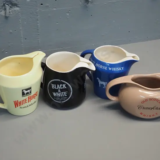 4 Scotch whisky water jugs all made by Wade. Tallest is H135