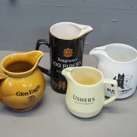 4 Scotch whisky water jugs - 3 made by Wade, Black & White by HCW Burleigh, tallest is H170