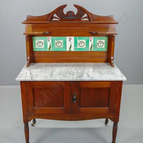 art nouveau style marble topped wash stand with pierced & carved cresting rail, tile back, 2 panelled doors on turned