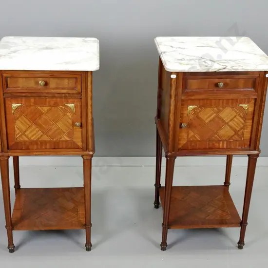 pair of French walnut bedside cabinets with parquetry inlay, marble tops, single drawer and door, brass knobs and corner