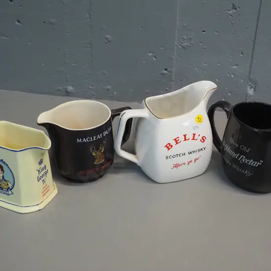 4 Scotch whisky water jugs all made by Wade. Tallest is H140