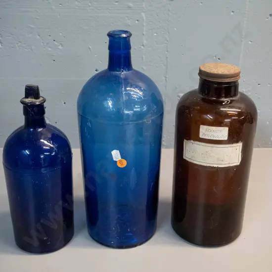 3 vintage bottles - smaller blue one has stuck stopper, brown one with "Rocket Fuel" label. Tallest H340