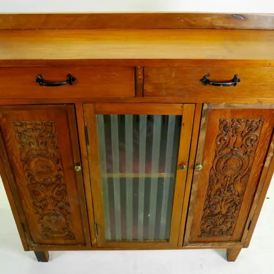 mixed timber sideboard w/2 carved wood & one glazed doors, 2 drawers, mixed handles, polish needs work H-950 W-940 D-310