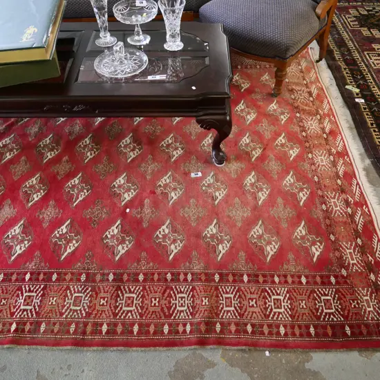 large hand-knotted Persian style floor rug - mainly red tones L3000 W2000