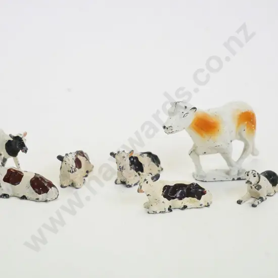7 small vintage painted lead animals - 6 cows and a crouching dog