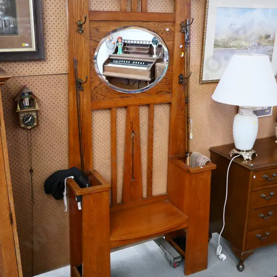 deco solid oak hall stand & seat w/umbrella tray, oval bevelled mirror, 4 brass coathooks, some borer in back H1870 W930