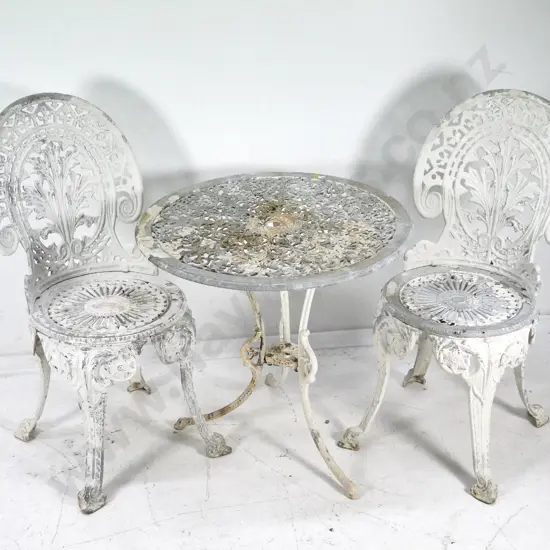cast aluminium outdoor table and 2 chairs - much of the paint worn away. Table H-620 Diameter 655