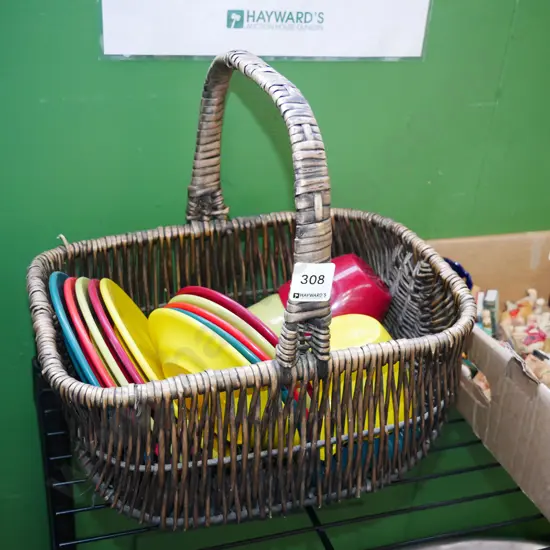 cane basket and Duraware plastic plates, cups, saucers