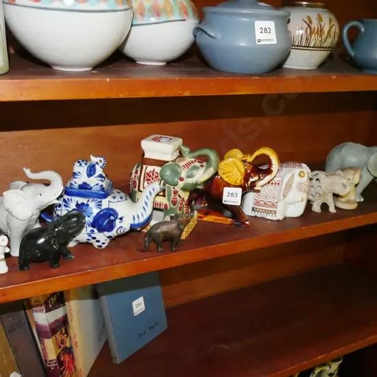 shelf of elephants figurines - some have damage