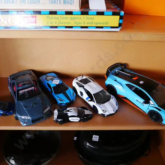 shelf of plastic and die cast model vehicles
