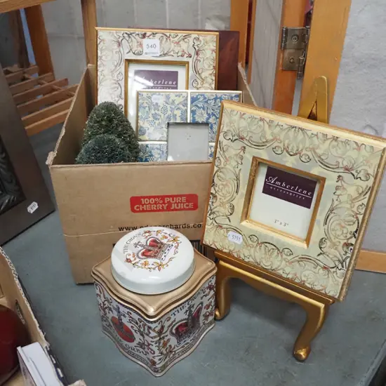 box; photo frames, faux topiary trees, tin tea caddy, easel