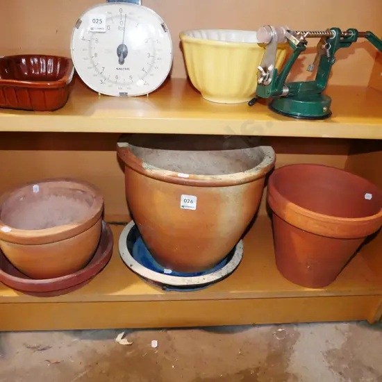 shelf of terracotta garden planters