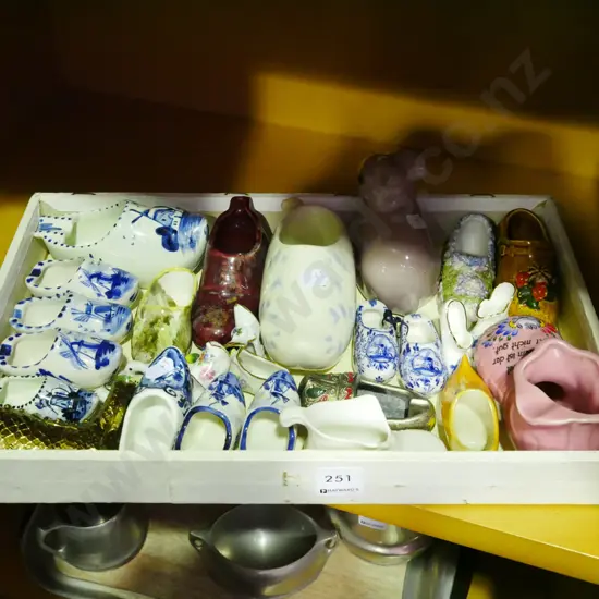 wooden tray of ceramic shoes and clogs