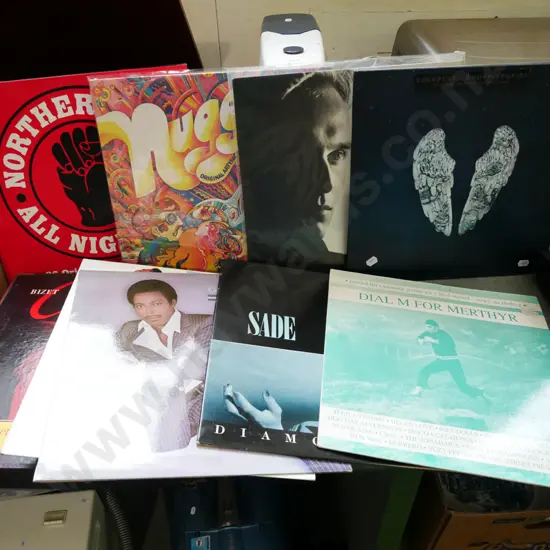 stack of LPs; Coldplay, Bose, Sade etc