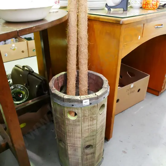 wooden barrel, 2 jute covered stakes