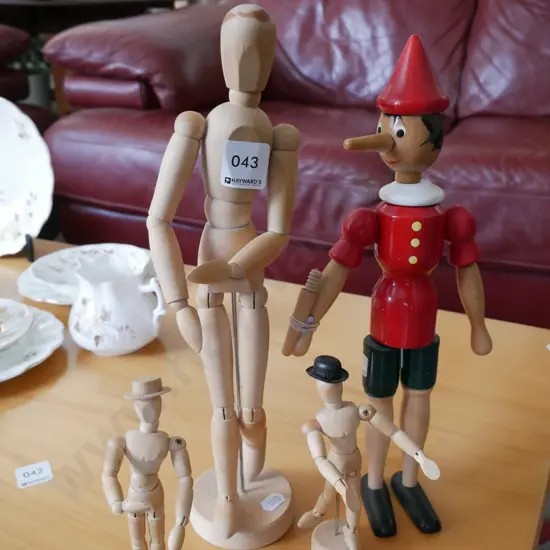 3 wooden articulated artists modles and a painted wood Pinocchio doll