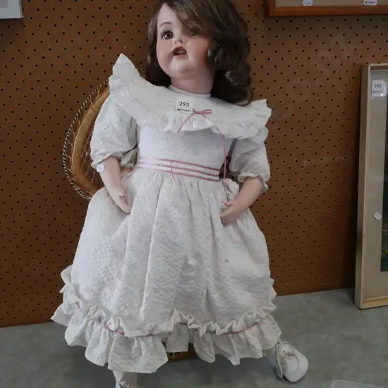porcelain display doll and cane chair