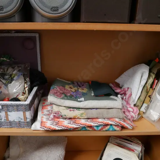 shelf of partially completed needleworks etc