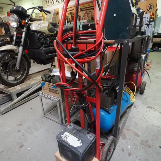 car battery charger - battery and jumper leads on sack barrow