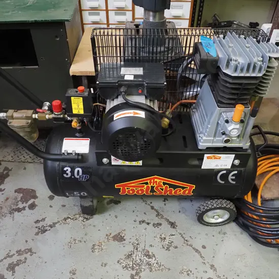 Toolshed 3 hp air compressor with orange and black air hoses
