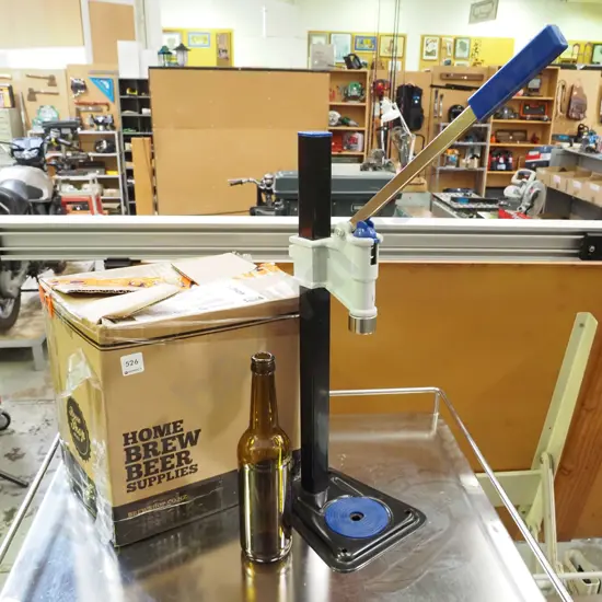 beer bottle capper and box of home brew beer bottles