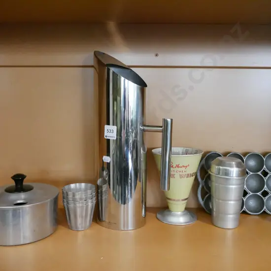 shelf; stainless steel water jug, aluminium shaker, small gem iron