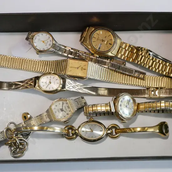 tray of golden wristwatches