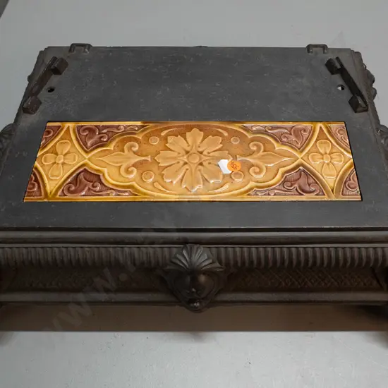 vintage cast iron base from stove or heater - crack to inset floral tile. H-150 W-520 D-390