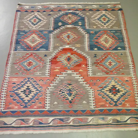 Turkish hand-woven wool floor rug in multi-colour geometric pattern, some fading L-1700 W-1380
