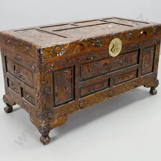 vintage Chinese profusely carved camphorwood chest with circular brass lock plate and escutcheon, cabriole feet. Brass