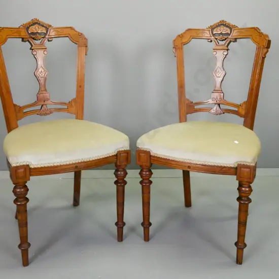 pair of Victorian walnut carved-back chairs with turned front legs, pale green upholstered seats - some fading to