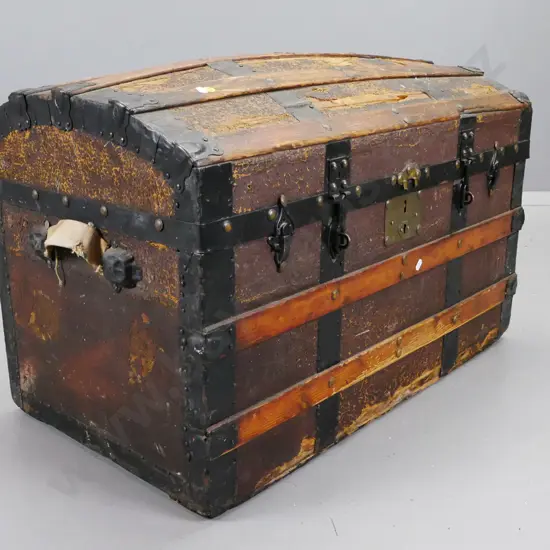 vintage dome-top Saratoga trunk with timber slats, replaced handles, overall wear and tear, damage to