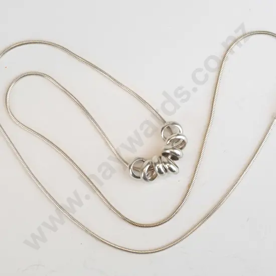 silver necklace with 7 rings stamped 925