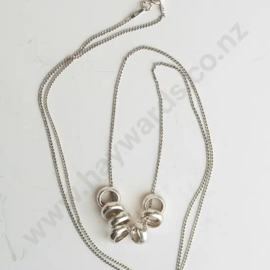 silver necklace with 7 small rings