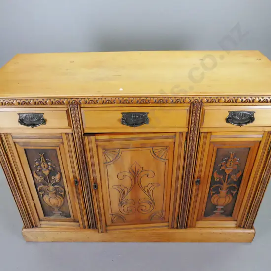 colonial kauri and rimu sideboard - 3 drawers, 3 panelled doors, carved edge to top, on plinth base - top is loose,