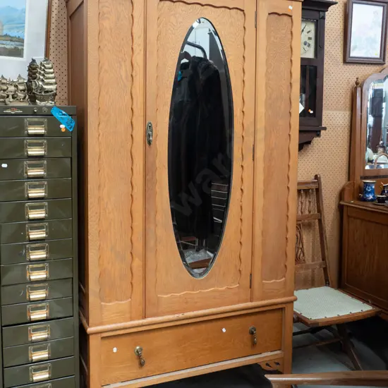 vintage oak wardrobe with oval bevelled edge mirror, oval panels to sides, bottom drawer with drop handles, on square