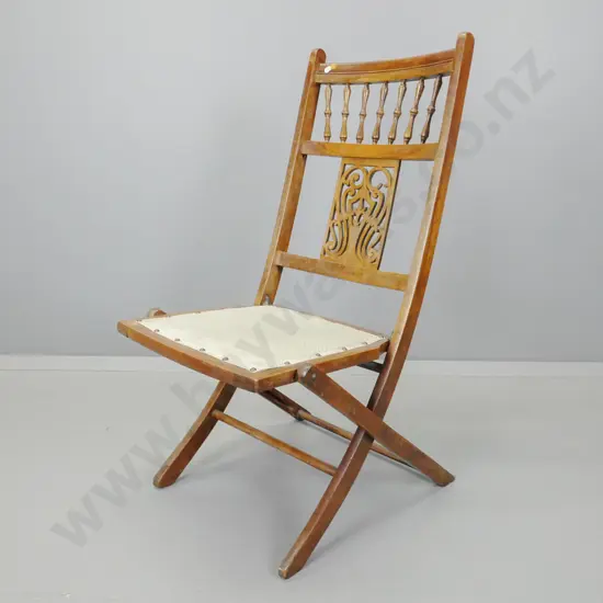 Edwardian beech folding chair with turned spindle gallery - some damage to pierced carved back splat, staining to polish