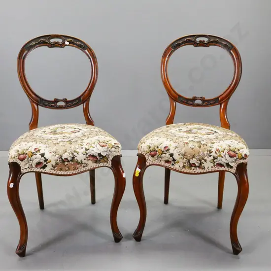 pair of Victorian walnut balloon back side chairs with pierced foliate carving to back, on sweeping corded cabriole legs