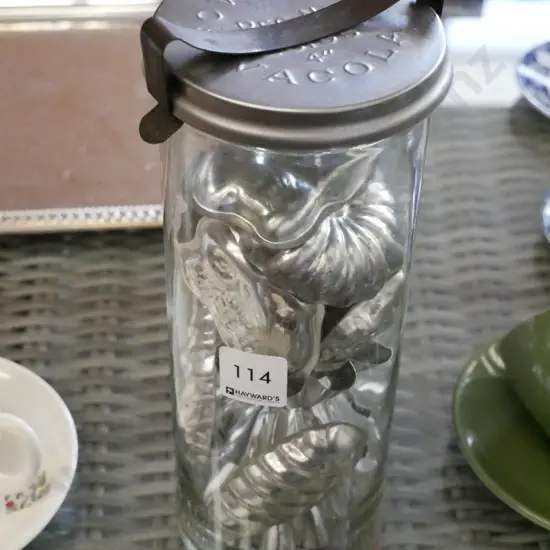 tall glass jar of chocolate moulds