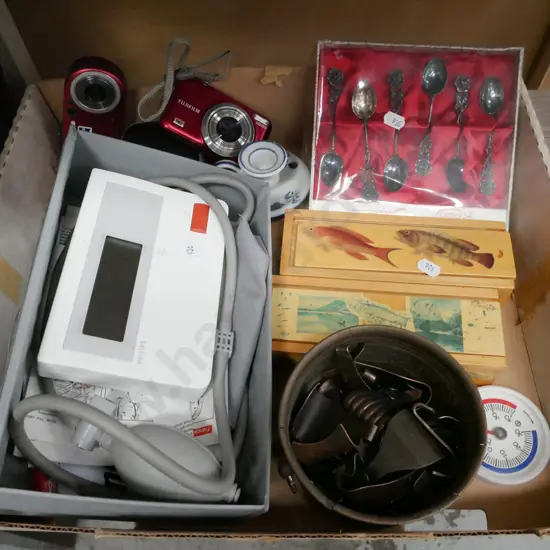 box; digital blood pressure monitor, books, thermometer, digital camera etc