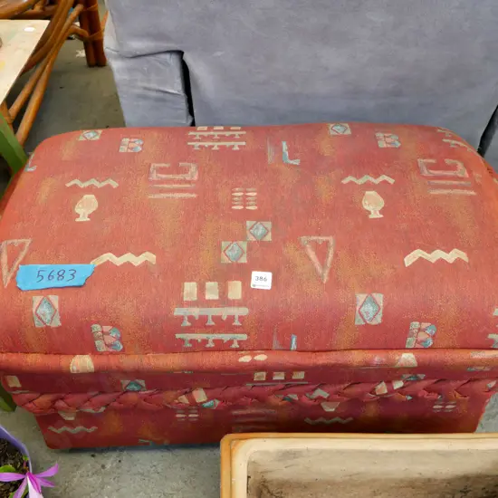 orange upholstered storage ottoman on casters