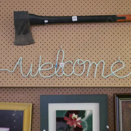 bent metal Welcome sign