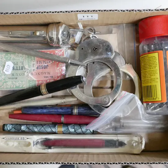 small box; Fountain pens and nibs, hand cuffs, vintage torch etc