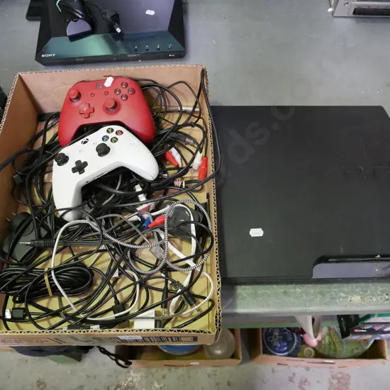 Playstation 3, box of X-box controllers and various cables and cords