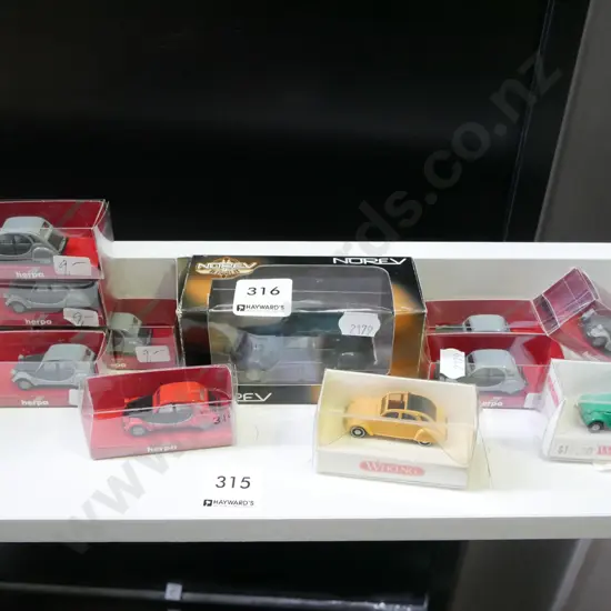 various miniature model vehicles and 1 larger vehicle