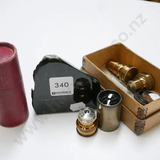 small piece of polished stone & box of various microscope lenses & glass plates